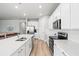 Bright, open-concept kitchen features large island, stainless appliances, and white cabinets at 44325 Saddlewood Ct, Punta Gorda, FL 33982