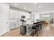 Modern kitchen boasts white cabinets, stainless appliances, and large center island at 44325 Saddlewood Ct, Punta Gorda, FL 33982