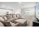 Spacious living area with sectional seating, modern decor, and views to the kitchen area at 44325 Saddlewood Ct, Punta Gorda, FL 33982