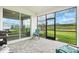 Screened patio with brick flooring features comfortable seating and open views of the green backyard and blue skies at 44325 Saddlewood Ct, Punta Gorda, FL 33982