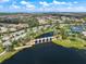 Aerial view of the community with homes, roads, lakes, and the bridge with multiple arches crossing the lake at 4506 Stickley Ct, Palmetto, FL 34221