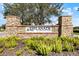 Stone sign indicating the entrance to the Esplanade at Artisan Lakes community, surrounded by greenery at 4506 Stickley Ct, Palmetto, FL 34221