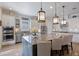 Bright kitchen featuring white cabinets, stainless steel appliances, granite countertops and decorative hanging pendant lights at 4506 Stickley Ct, Palmetto, FL 34221