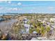 Stunning aerial view of a residential neighborhood with a pond and mature trees at 4710 Gleason Ave, Sarasota, FL 34242