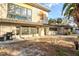 Spacious backyard featuring an outdoor grill, patio, and view of the home's unique architecture at 4710 Gleason Ave, Sarasota, FL 34242