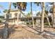 Backyard featuring tall Palm trees and the rear of the house at 4710 Gleason Ave, Sarasota, FL 34242