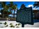 Informative sign about Siesta Public Beach with palm trees and clear blue sky in the background at 4710 Gleason Ave, Sarasota, FL 34242