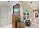 Bright hallway with ample natural light from large windows, tile flooring, and storage closet at 4710 Gleason Ave, Sarasota, FL 34242