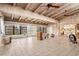 Spacious living room with beamed ceiling, tile floors, and large windows overlooking the yard at 4710 Gleason Ave, Sarasota, FL 34242