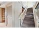 Carpeted staircase with white railing leading to the second floor at 4710 Gleason Ave, Sarasota, FL 34242