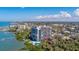 Elevated view of a condo showcasing its waterfront location, a nearby pool, and lush green landscaping highlighted by arrow at 500 N Osceola Ave # 203, Clearwater, FL 33755