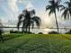 Beautifully maintained lawn with palm trees providing shade, overlooking the waterfront at 500 N Osceola Ave # 203, Clearwater, FL 33755