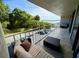Relax on this condo's private balcony with a seating area and views of lush greenery and distant water at 500 N Osceola Ave # 203, Clearwater, FL 33755