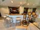 The bar area features modern stools, mirrored wall, and adjoins the eat-in kitchen at 500 N Osceola Ave # 203, Clearwater, FL 33755