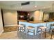 The bar area features modern stools, a mirrored wall, and is situated adjacent to the eat-in kitchen at 500 N Osceola Ave # 203, Clearwater, FL 33755