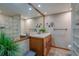 Bathroom featuring double sinks, wood cabinetry, and a glass block shower at 500 N Osceola Ave # 203, Clearwater, FL 33755