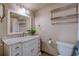 Well-lit bathroom featuring a marble vanity, stylish mirror, and modern toilet with convenient shelving at 500 N Osceola Ave # 203, Clearwater, FL 33755