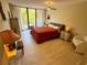 Bedroom featuring a balcony door with light wood flooring and decor at 500 N Osceola Ave # 203, Clearwater, FL 33755