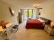Bedroom with a ceiling fan, balcony access, and decor at 500 N Osceola Ave # 203, Clearwater, FL 33755