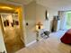 Brightly lit bedroom that opens to an exterior balcony with a tiled hallway at 500 N Osceola Ave # 203, Clearwater, FL 33755