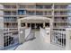 Exterior shot of the building entrance with a white fence and well-maintained grounds at 500 N Osceola Ave # 203, Clearwater, FL 33755