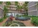 Beautiful courtyard with lush landscaping, water feature, and view of the condo at 500 N Osceola Ave # 203, Clearwater, FL 33755