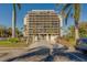 Beautiful high rise condo building with lush landscaping and white entry gate at 500 N Osceola Ave # 203, Clearwater, FL 33755