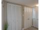Bright hallway featuring multiple storage closets with white louvered doors and modern hooks for coats and accessories at 500 N Osceola Ave # 203, Clearwater, FL 33755