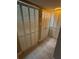 Hallway featuring light wood floors and closet space with shutters at 500 N Osceola Ave # 203, Clearwater, FL 33755