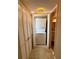 Hallway featuring light wood floors, hall closets, and a washer/dryer at 500 N Osceola Ave # 203, Clearwater, FL 33755