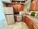 Updated kitchen featuring stainless steel appliances, granite countertops, and warm wood cabinetry at 500 N Osceola Ave # 203, Clearwater, FL 33755