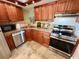 Updated kitchen with stainless steel appliances, granite countertops, and wood cabinets at 500 N Osceola Ave # 203, Clearwater, FL 33755