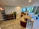 Open-concept living space with a kitchen bar, mirrored wall, and access to the balcony at 500 N Osceola Ave # 203, Clearwater, FL 33755