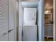 Convenient laundry room featuring a stacked washer and dryer and plenty of shelving space at 500 N Osceola Ave # 203, Clearwater, FL 33755