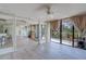 Bright living room with floor-to-ceiling windows, balcony access, and mirrored wall accents at 500 N Osceola Ave # 203, Clearwater, FL 33755