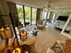 Open living area features a couch, view of the balcony, and an adjacent bedroom at 500 N Osceola Ave # 203, Clearwater, FL 33755