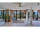 Bright living room featuring a ceiling fan, sliding glass doors and a view of the surrounding nature at 500 N Osceola Ave # 203, Clearwater, FL 33755