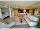 Bright living area includes a comfortable seating area, bar seating, and views into the bedroom at 500 N Osceola Ave # 203, Clearwater, FL 33755