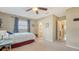 Relaxing bedroom with carpeted floors, an attached bathroom, and an open doorway at 5308 39Th W Ave, Bradenton, FL 34209