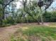 Spacious backyard featuring mature trees and lush greenery, offering privacy and natural beauty at 5714 Garden Lakes Fern, Bradenton, FL 34203