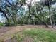 Expansive backyard boasting mature trees and lush greenery, perfect for outdoor activities and relaxation at 5714 Garden Lakes Fern, Bradenton, FL 34203