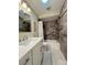 Well-lit bathroom showcasing a modern vanity, tile flooring, and shower with stylish accents at 5714 Garden Lakes Fern, Bradenton, FL 34203
