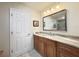Bathroom features a granite countertop vanity, wood cabinets and a framed mirror at 5714 Garden Lakes Fern, Bradenton, FL 34203