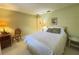 Bedroom with light yellow walls, a white bed and decor and furnishings at 5714 Garden Lakes Fern, Bradenton, FL 34203