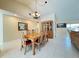 Traditional dining room with wood table, seating for six, and decorative chandelier at 5714 Garden Lakes Fern, Bradenton, FL 34203