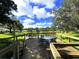 Picturesque dock overlooking a serene lake, furnished with tables and chairs, perfect for relaxing or entertaining at 5714 Garden Lakes Fern, Bradenton, FL 34203