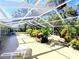 Spacious, screened lanai featuring lush landscaping, perfect for relaxing and entertaining outdoors at 5714 Garden Lakes Fern, Bradenton, FL 34203