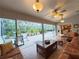 Relaxing sunroom showing seating area, floor to ceiling screened windows and view to the patio area at 5714 Garden Lakes Fern, Bradenton, FL 34203