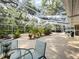 Expansive screened lanai with lush plantings offers a serene outdoor living and entertaining space at 5714 Garden Lakes Fern, Bradenton, FL 34203