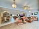 Spacious living room with wood-look flooring, ceiling fans, and comfortable wicker seating at 5714 Garden Lakes Fern, Bradenton, FL 34203